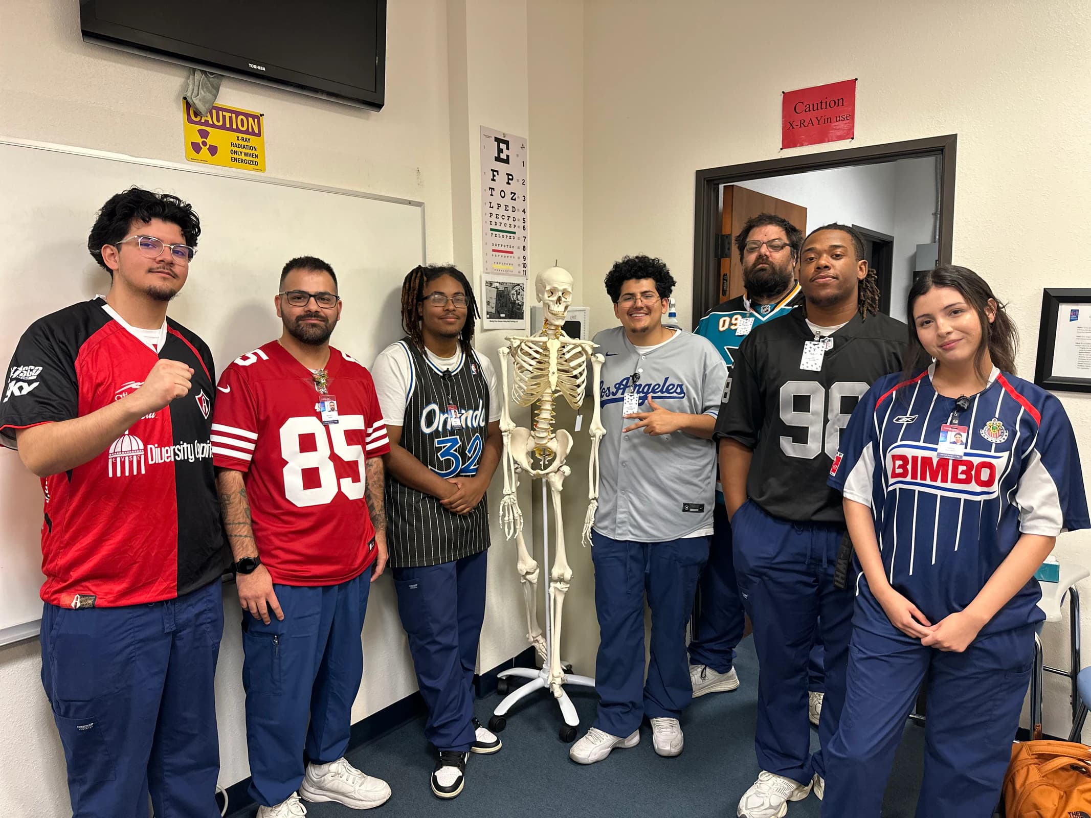 Limited Permit X-Ray Technician students gather with anatomy learning tools in a Moreno Valley classroom.