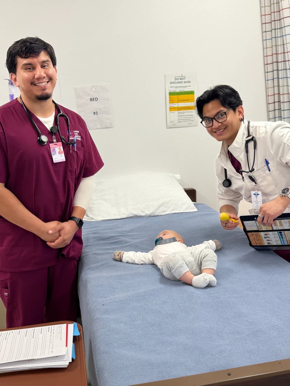 Vocational Nursing students in burgundy scrubs practice pediatric assessment skills.