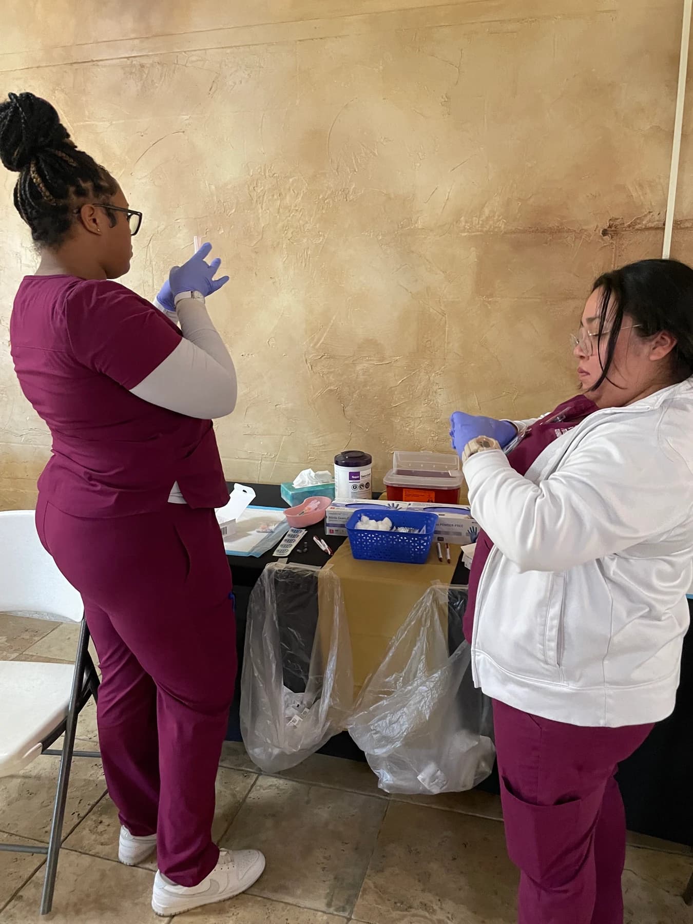 CCI students preparing healthcare screening supplies at the Senior Health Expo