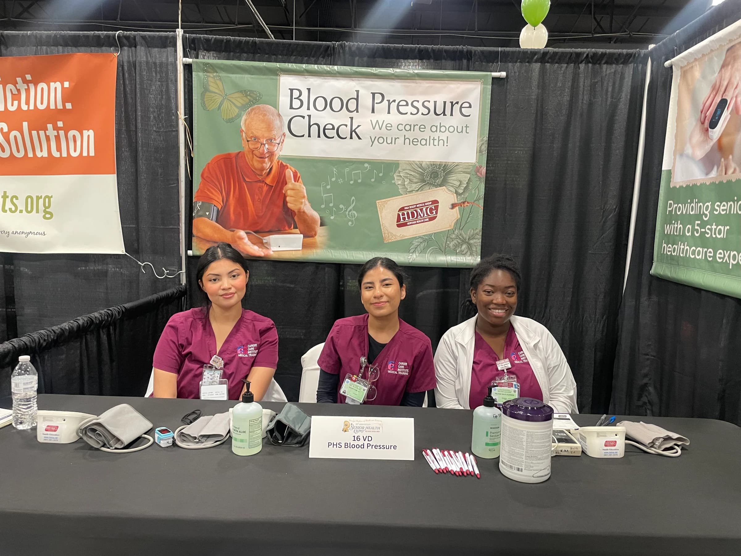 CCI students staffing a blood-pressure screening station at the Senior Health Expo