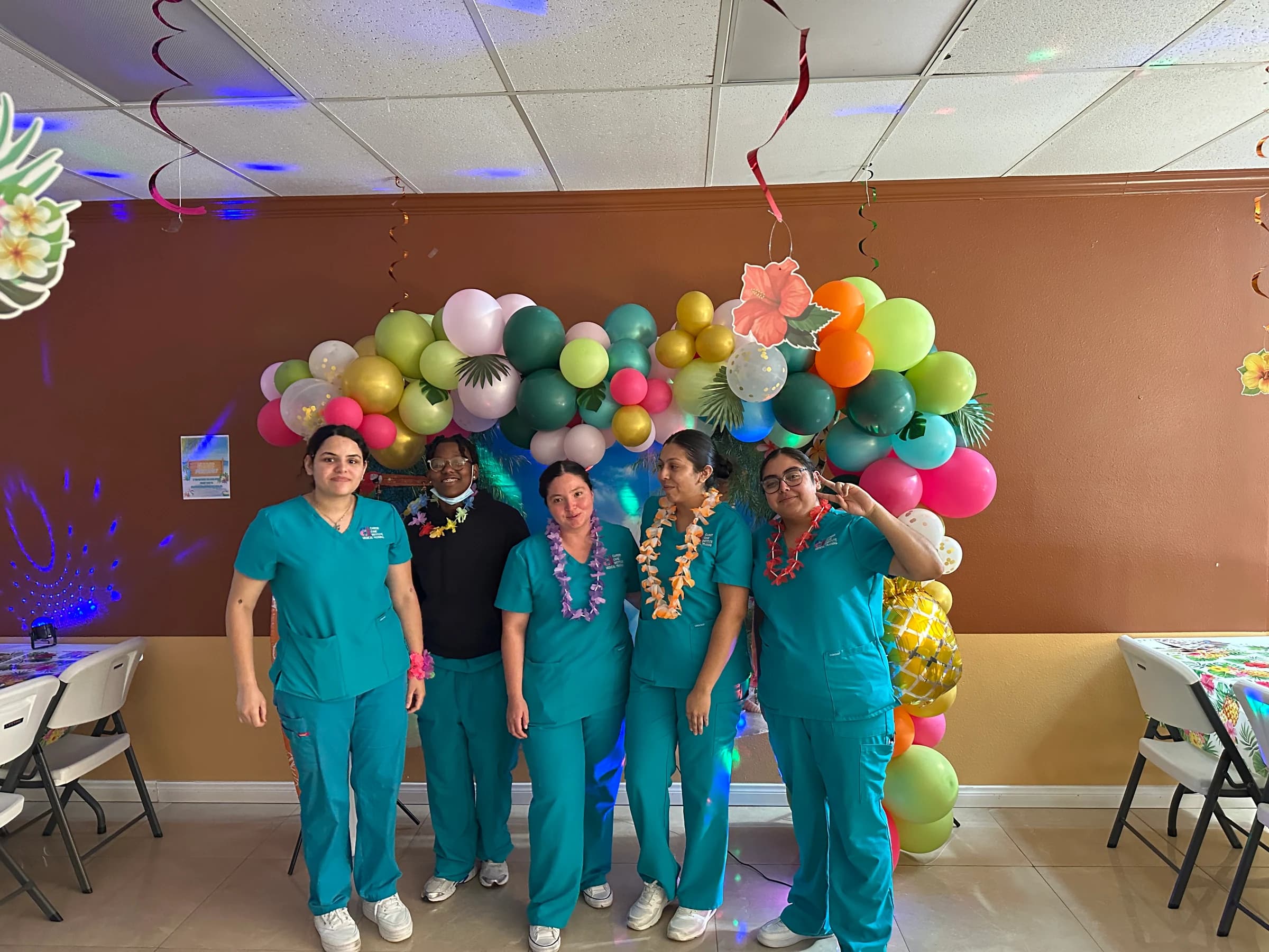 CCI students in scrubs gathered at a campus appreciation event