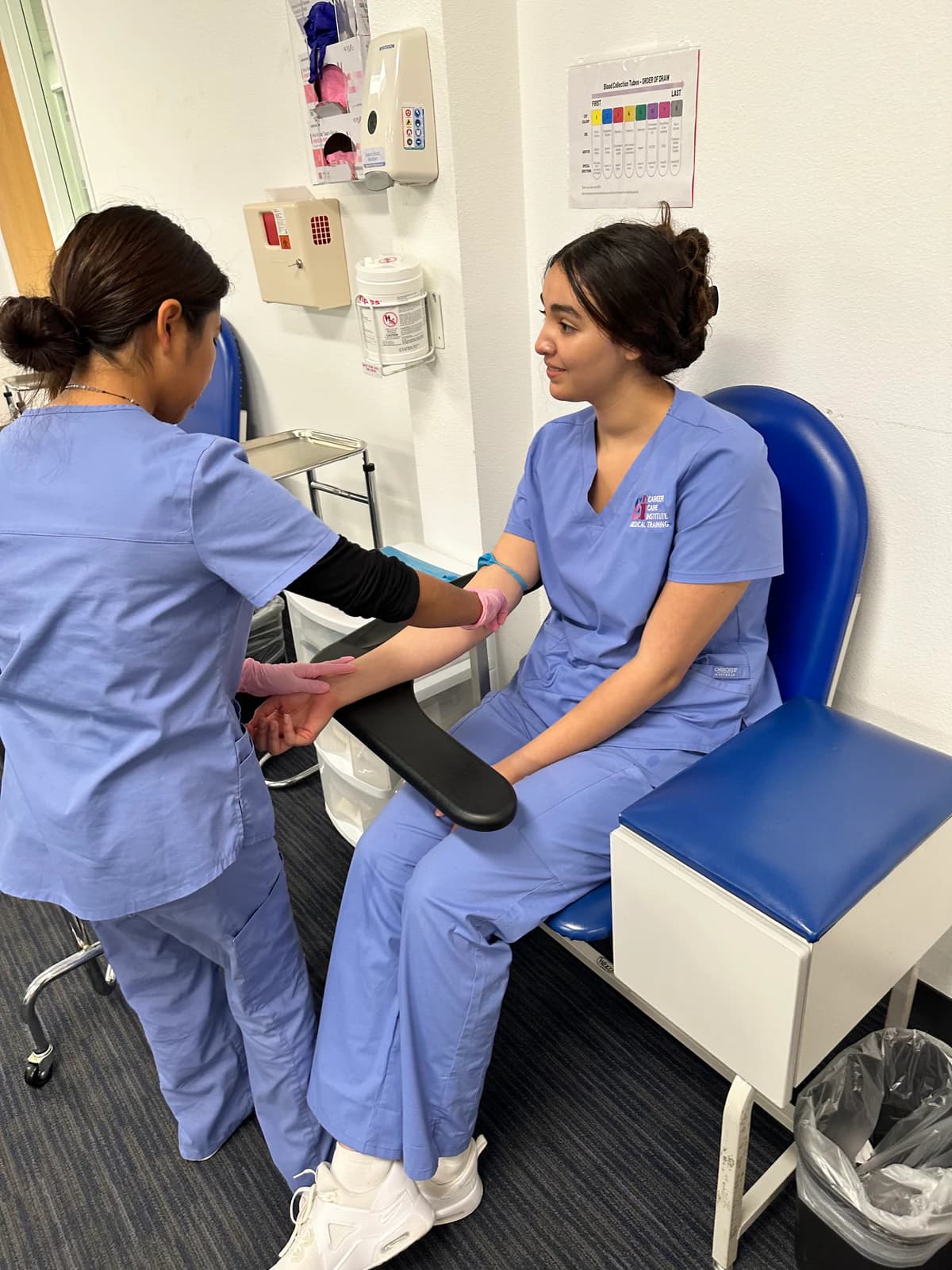 Medical Assisting students practice clinical skills together in a CCI Oxnard training lab.
