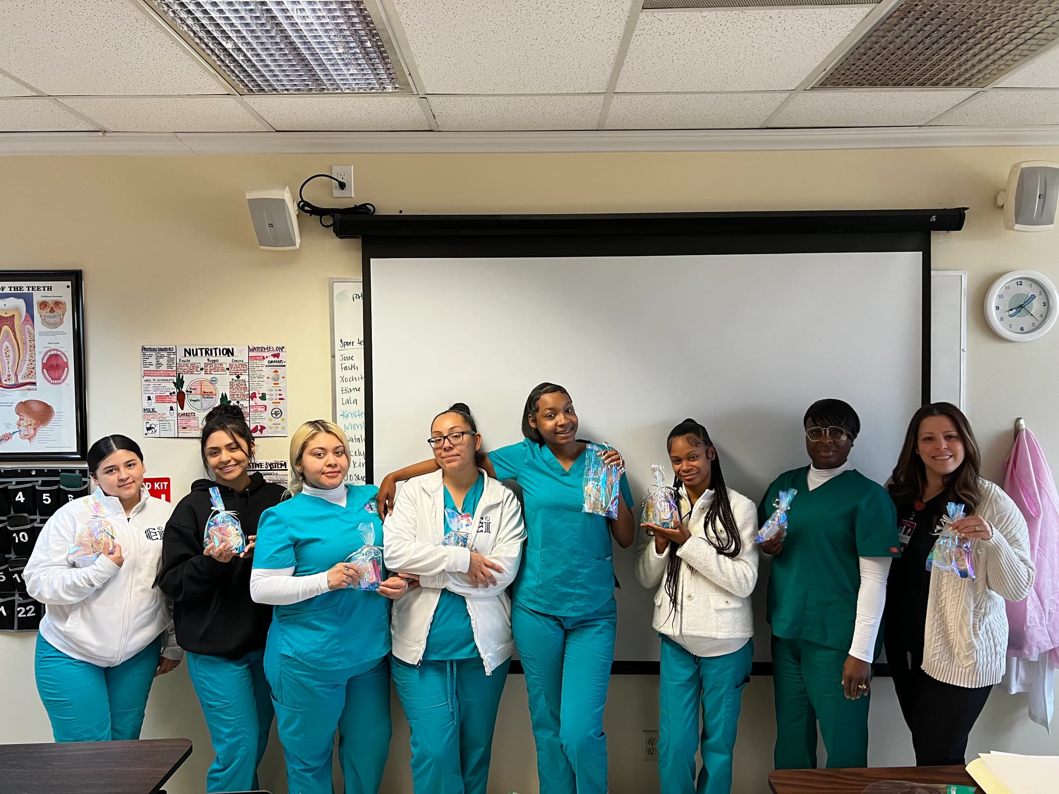 Dental Assisting students and an instructor gather in their Lancaster classroom.