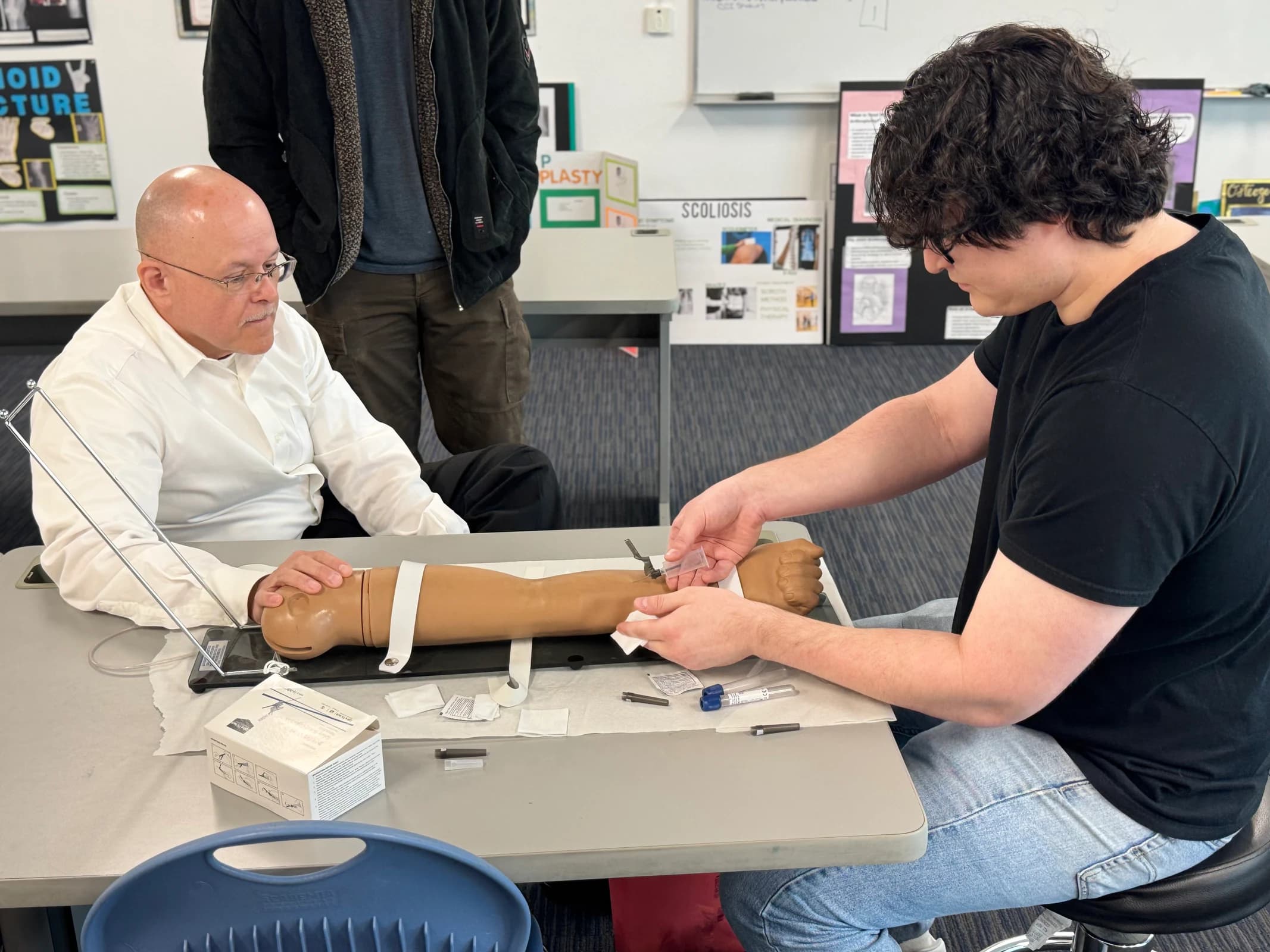 A Limited Permit X-Ray Technician student practices positioning with radiography equipment.