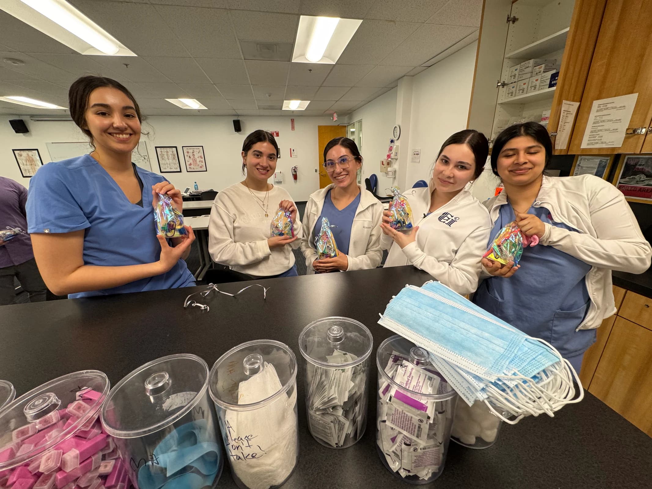Medical Assisting students stand together in a training lab.