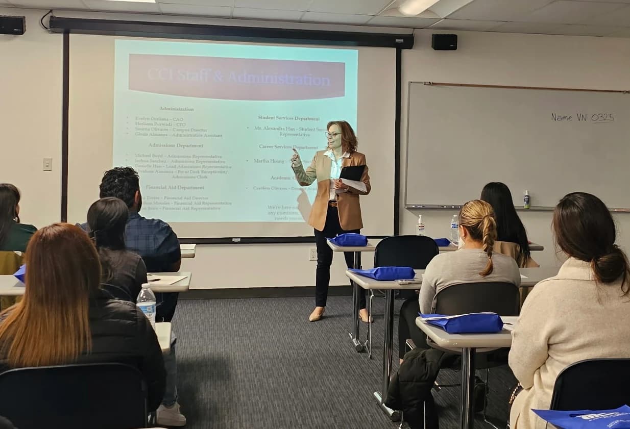 A CCI staff member presents to seated students in a classroom.